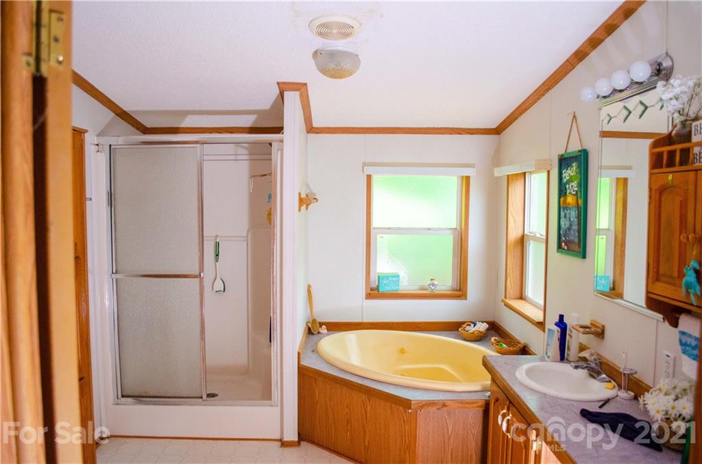 1560 Rhyne Road, Unit PT 19 Clover, SC 29710 - Photo 14 of 28 a bathroom with a tub a sink and a large mirror
