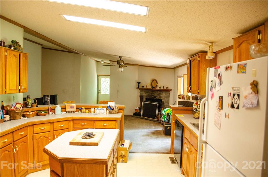 1560 Rhyne Road, Unit PT 19 Clover, SC 29710 - Photo 22 of 28 a kitchen with a refrigerator a stove top oven and a dining table