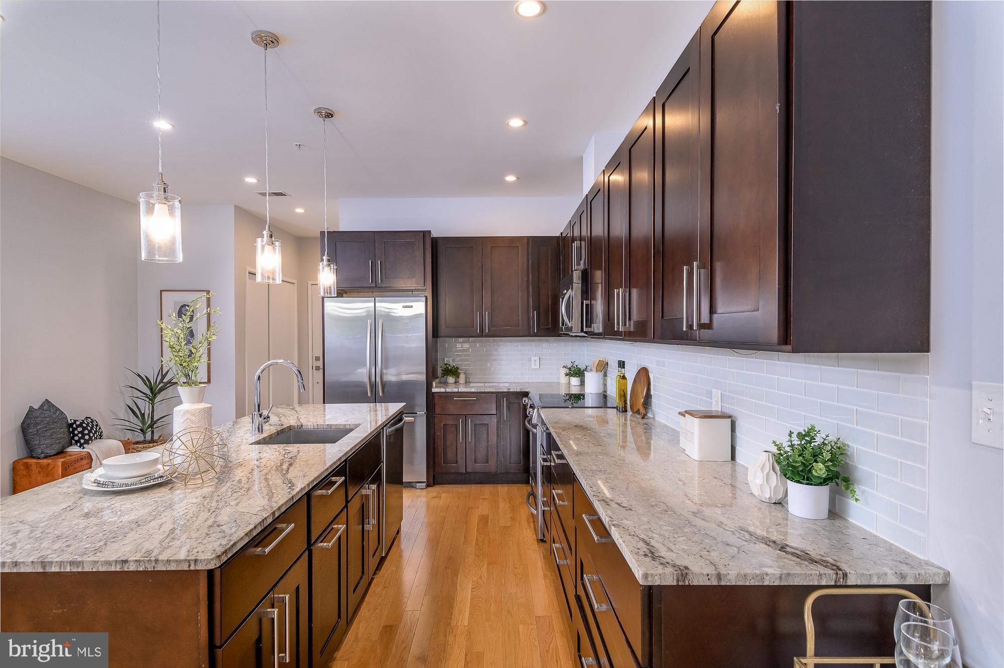 a kitchen with granite countertop lots of counter top space and wooden floor