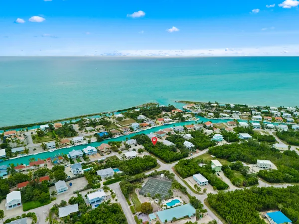 an aerial view of a houses with a yard