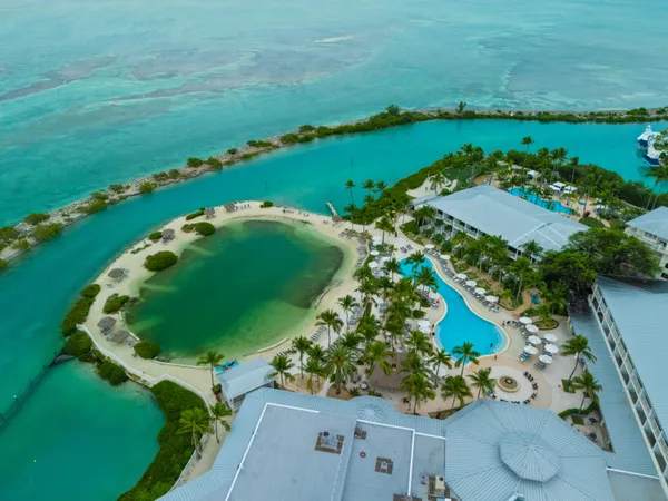 an aerial view of a golf course with a swimming pool
