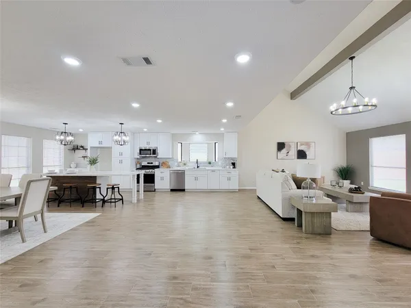 a living room with furniture and kitchen view