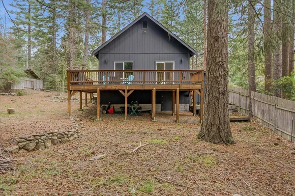 a view of a house with a yard and sitting area