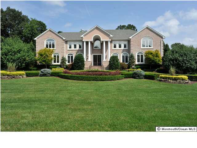 114 Stone Hill Road Colts Neck, NJ 07722 - Photo 1 of 25 a front view of a house with a garden