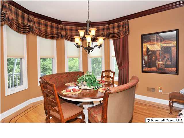 114 Stone Hill Road Colts Neck, NJ 07722 - Photo 11 of 25 a dining room with furniture a chandelier and window