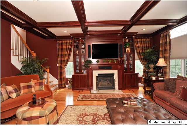 114 Stone Hill Road Colts Neck, NJ 07722 - Photo 12 of 25 a living room with furniture a flat screen tv and a fireplace