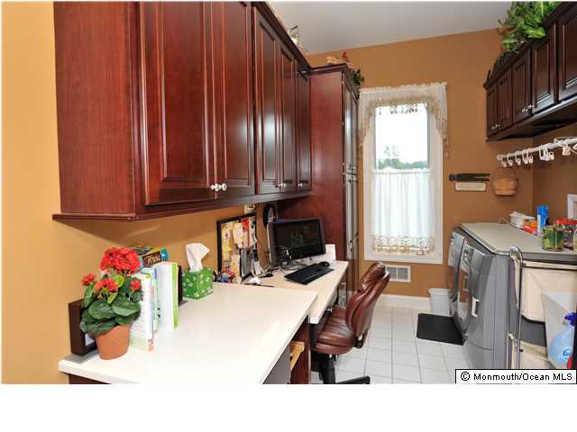 114 Stone Hill Road Colts Neck, NJ 07722 - Photo 13 of 25 a living room with furniture a flat screen tv and a window