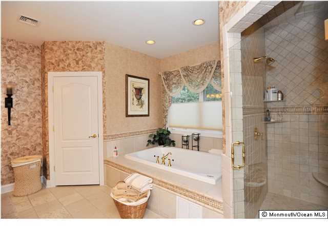 114 Stone Hill Road Colts Neck, NJ 07722 - Photo 18 of 25 a bathroom with a sink a bathtub and a shower