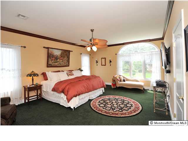 114 Stone Hill Road Colts Neck, NJ 07722 - Photo 20 of 25 a spacious bedroom with a bed dresser and a window