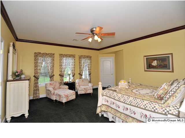 114 Stone Hill Road Colts Neck, NJ 07722 - Photo 21 of 25 a living room with furniture and a large window