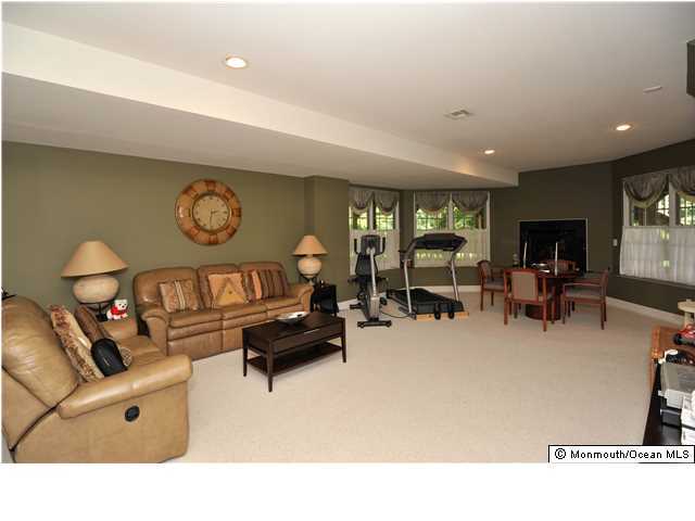 114 Stone Hill Road Colts Neck, NJ 07722 - Photo 23 of 25 a living room with furniture and a large window