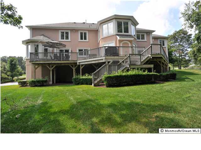 114 Stone Hill Road Colts Neck, NJ 07722 - Photo 25 of 25 a front view of a house with a garden and deck