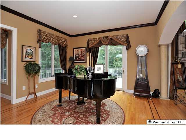 114 Stone Hill Road Colts Neck, NJ 07722 - Photo 4 of 25 a living room with furniture a window and a flat screen tv
