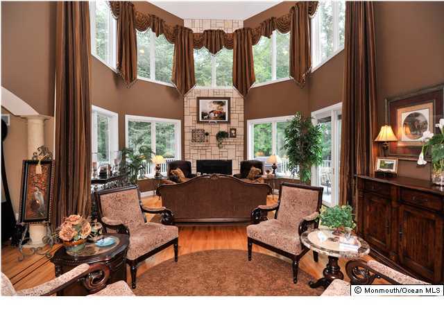 114 Stone Hill Road Colts Neck, NJ 07722 - Photo 7 of 25 a living room with furniture a chandelier and large window