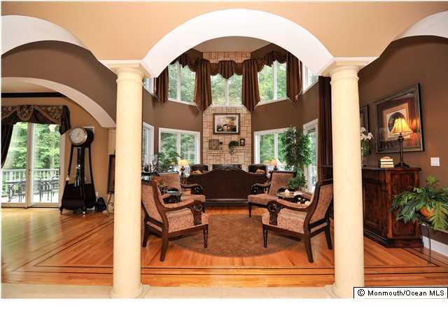 114 Stone Hill Road Colts Neck, NJ 07722 - Photo 8 of 25 a living room with furniture and a floor to ceiling window