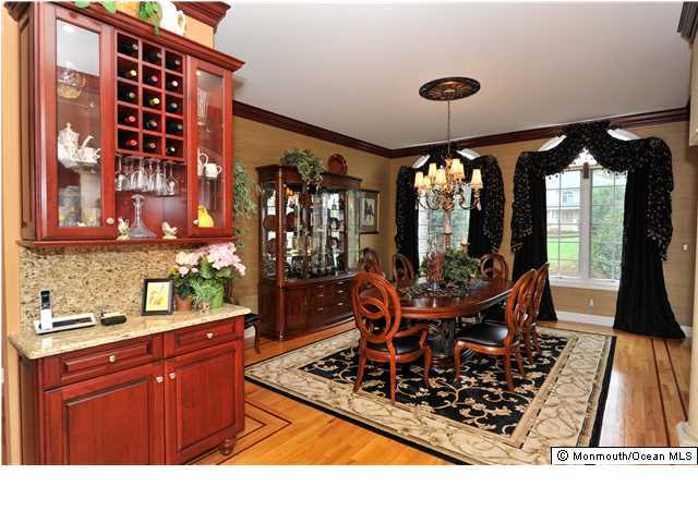 114 Stone Hill Road Colts Neck, NJ 07722 - Photo 9 of 25 a room with lots of wooden furniture and a large window
