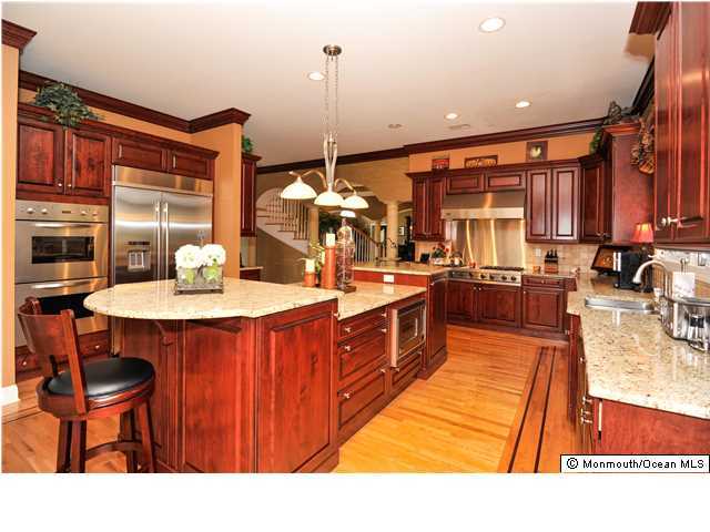 114 Stone Hill Road Colts Neck, NJ 07722 - Photo 10 of 25 a kitchen with stainless steel appliances kitchen island granite countertop a sink and cabinets