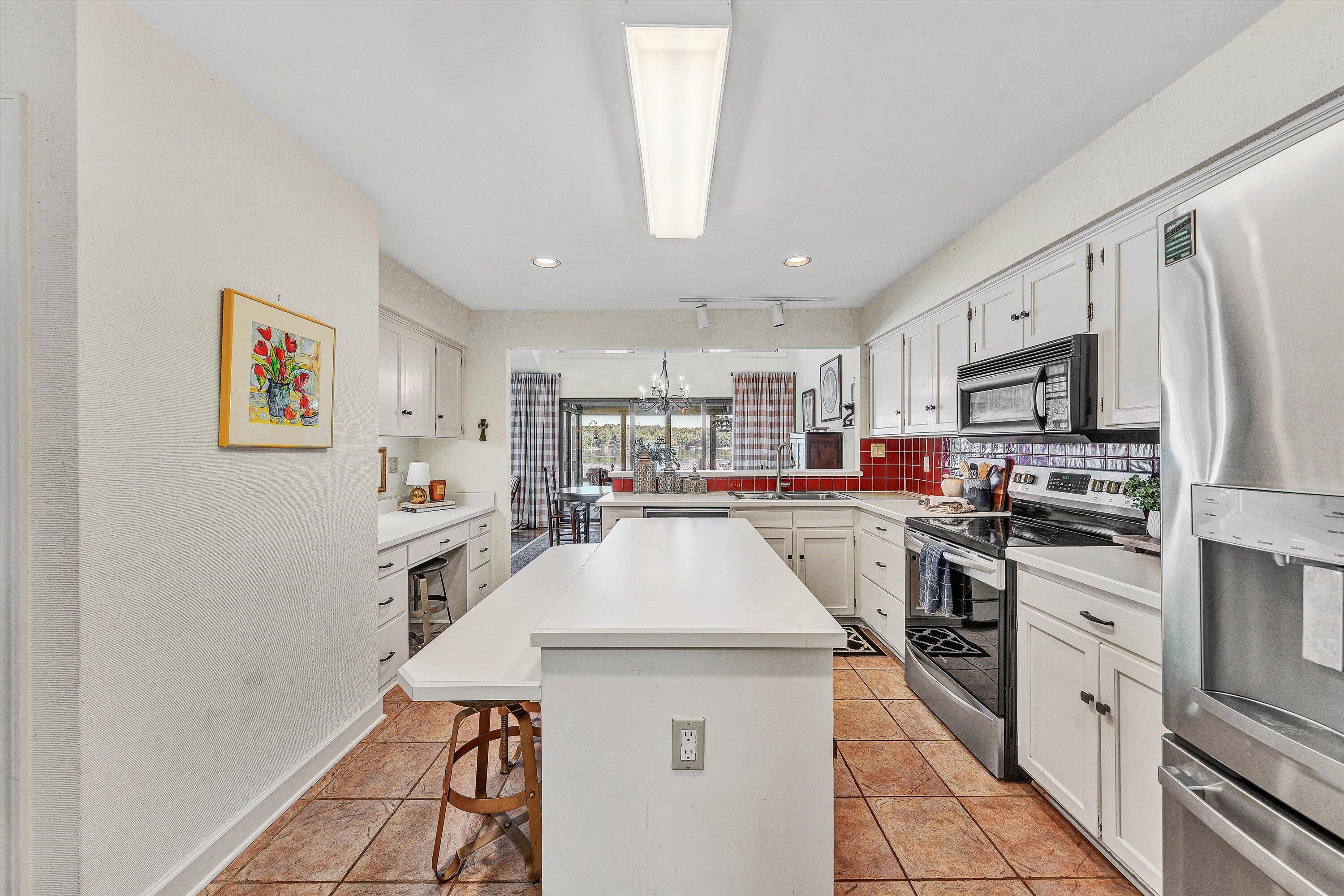 112 Gangplank Circle Moneta, VA 24121 - Photo 13 of 56 a kitchen with stainless steel appliances kitchen island granite countertop a refrigerator oven a sink dishwasher and white cabinets with wooden floor