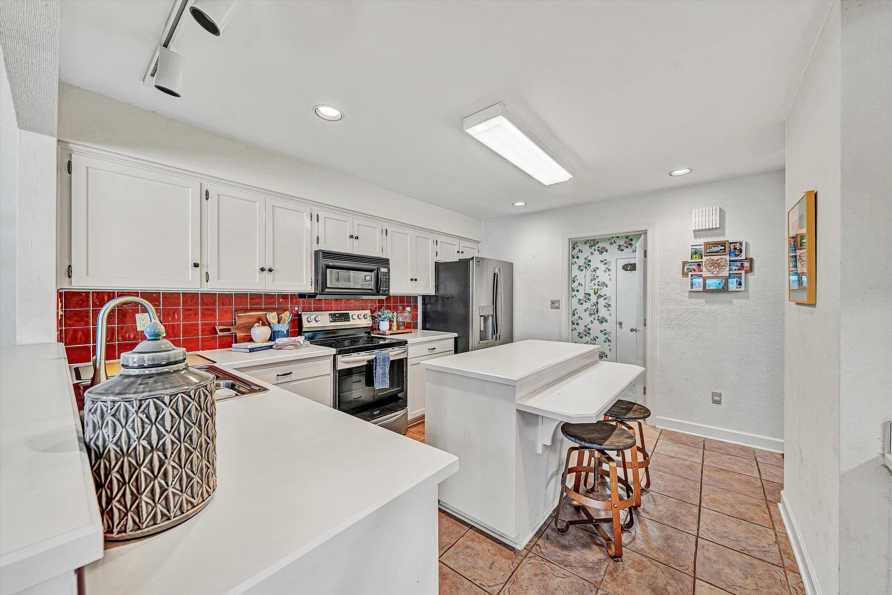 112 Gangplank Circle Moneta, VA 24121 - Photo 15 of 56 a open kitchen with stainless steel appliances granite countertop a dining table chairs and white cabinets