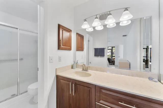 a bathroom with a sink a toilet and a mirror