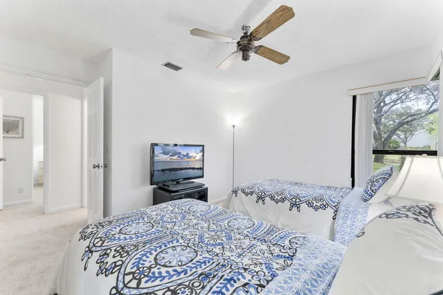 a bedroom with a bed dresser and a window