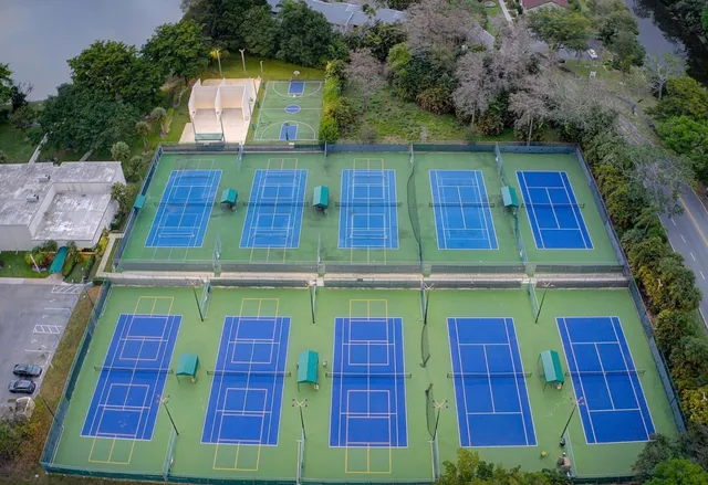 an aerial view of a house with garden space and lake view