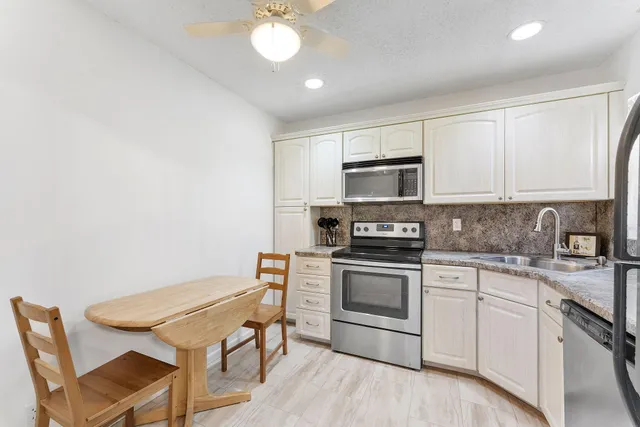 a kitchen with a stove a sink and a microwave