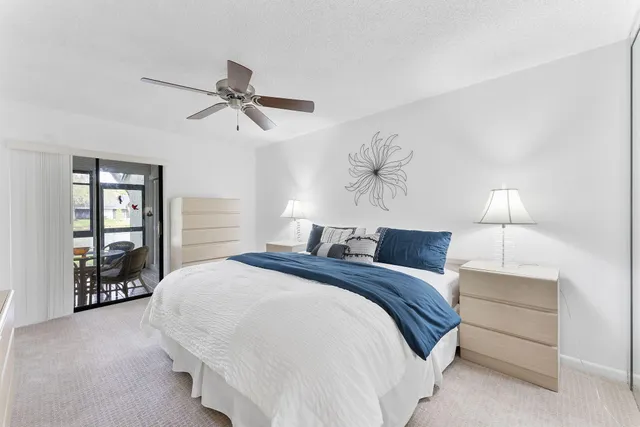 a bedroom with a bed and dresser with mirror