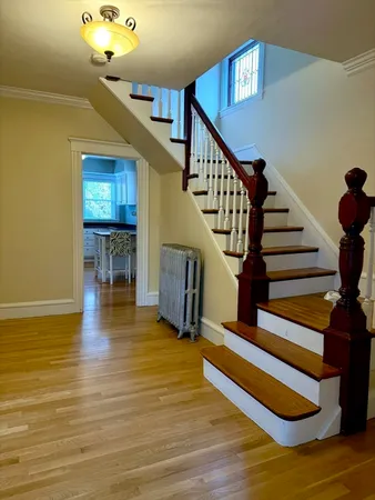 a view of entryway livingroom and hall with wooden floor