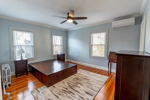 a living room with wooden floor and a window