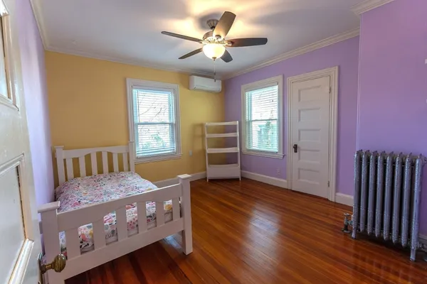 a bedroom with furniture and wooden floor