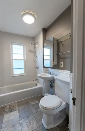 a bathroom with a toilet a sink and bathtub