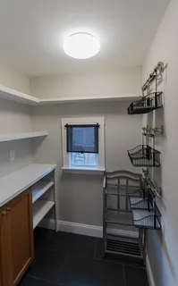 a view of storage and utility room with racks on the wall