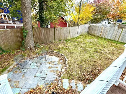 a view of a backyard with a wooden fence
