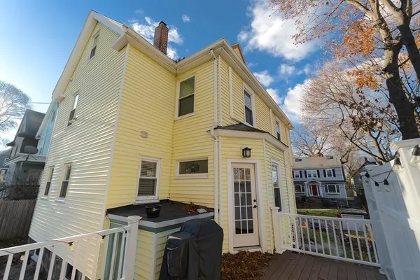 a view of a blue house with large windows