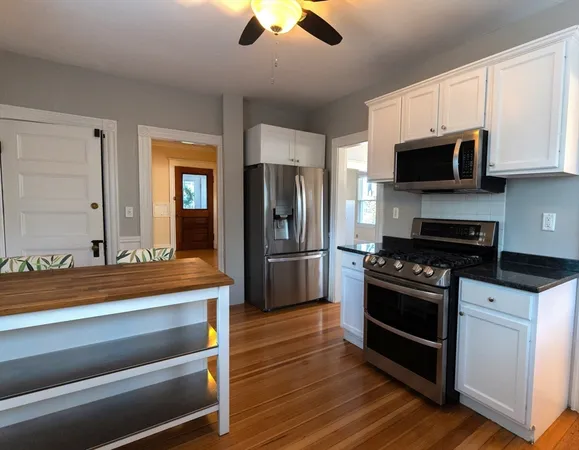a kitchen with stainless steel appliances granite countertop a stove and a refrigerator
