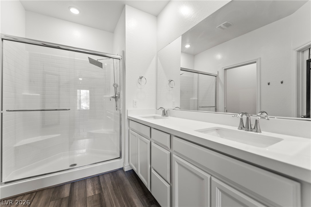 7204 North Decatur Boulevard, Unit 5 North Las Vegas, NV 89084 - Photo 11 of 34 Clean lines and a spacious dual vanity define this updated primary bathroom retreat.