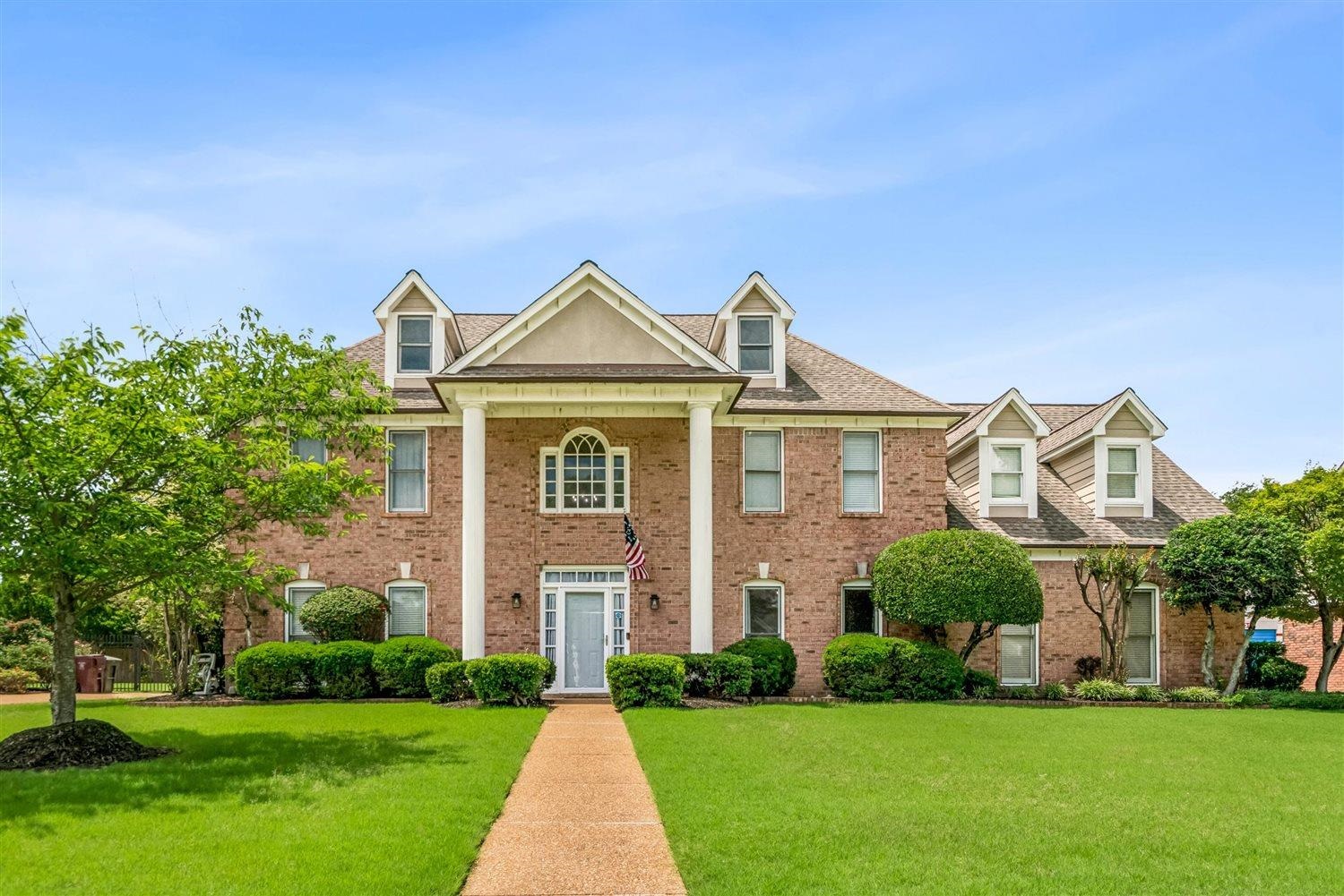 1489 John Ridge Drive Collierville, TN 38017 - Photo 1 of 39 a front view of a house with a yard