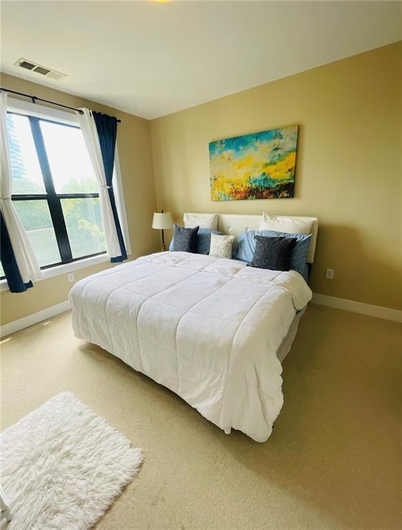 799 Hammond Drive Atlanta, GA 30328 - Photo 12 of 21 a bedroom with a bed and a large window