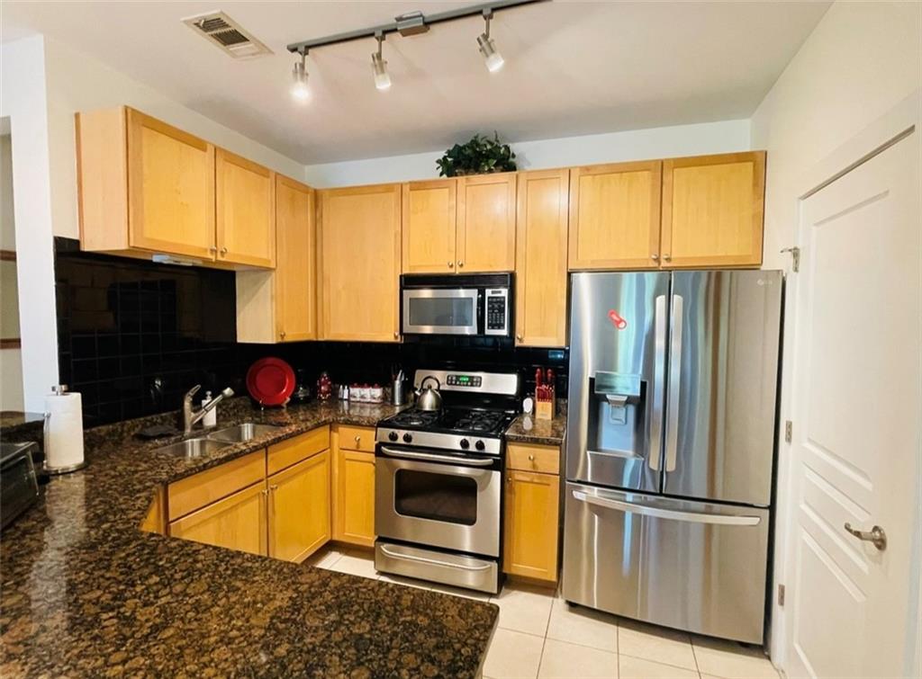 799 Hammond Drive Atlanta, GA 30328 - Photo 9 of 21 a kitchen with stainless steel appliances granite countertop a refrigerator a stove a sink dishwasher and a microwave