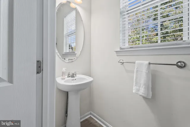 a kitchen with refrigerator a sink and white cabinets