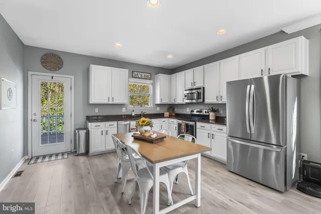 a kitchen with wooden cabinets and stainless steel appliances