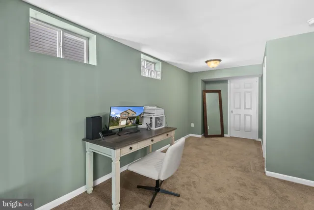 a living room with furniture and stairs