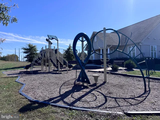 a view of a backyard with a patio and fire pit