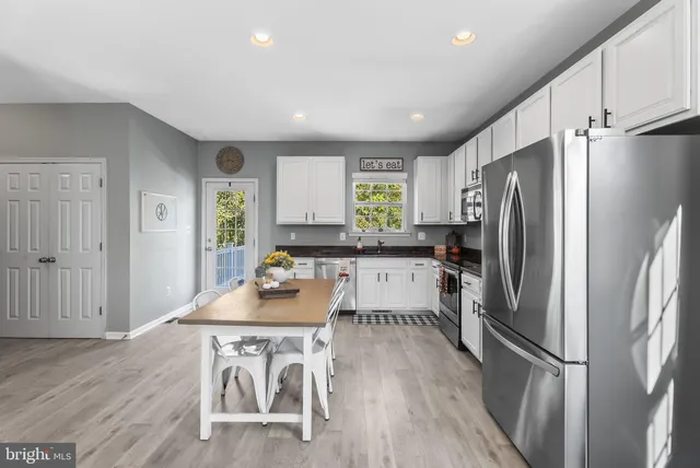 a living room with furniture a fireplace and a window