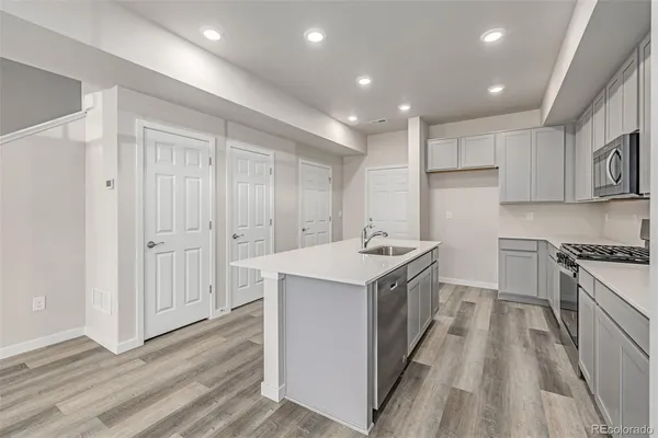 a kitchen with a sink stove and cabinets