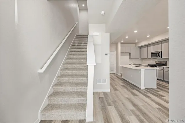 a view of kitchen with sink microwave and stove