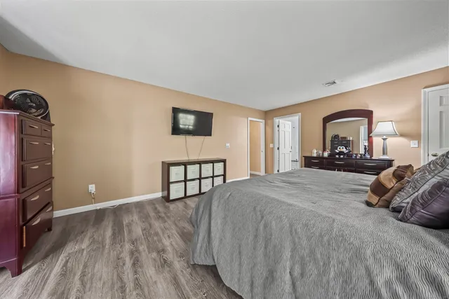 a bedroom with a bed and a tv on table