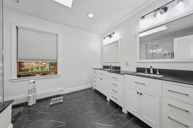 a spacious bathroom with a sink a mirror and a bathtub