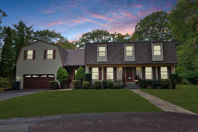 a front view of a house with a garden